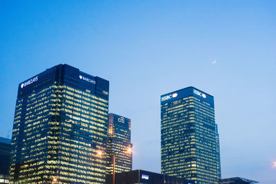 Low angle view of modern buildings against blue sky