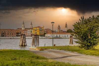 Buildings in city against sky during sunset