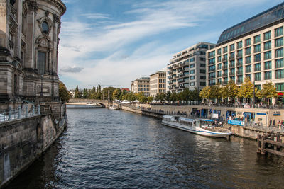 View of river in city against sky