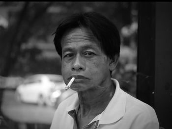 Portrait of man smoking cigarette