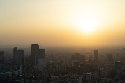 Cityscape against sky during sunset