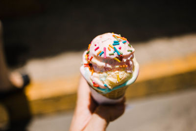 Close-up of hand holding ice cream cone