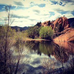 Scenic view of lake in forest against sky