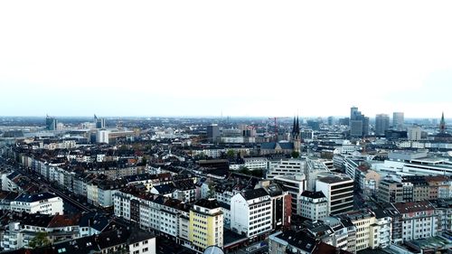 High angle view of buildings in city against clear sky