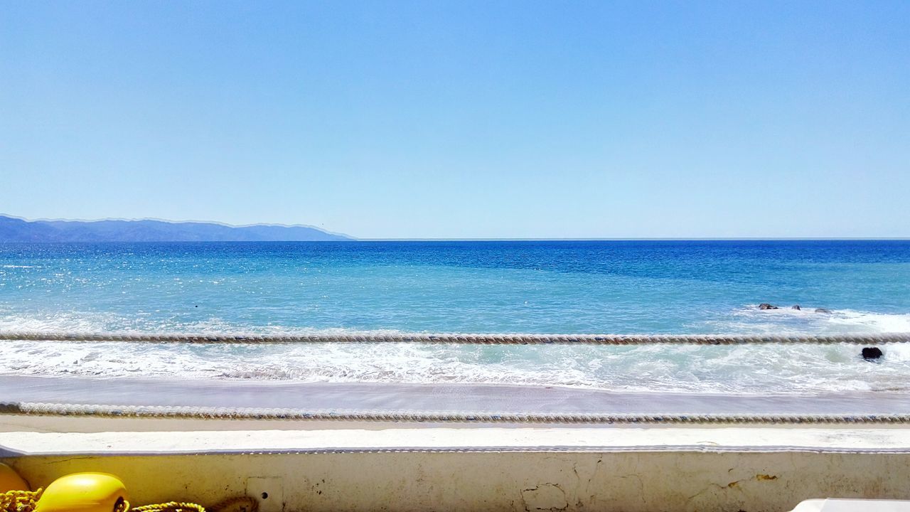 sea, horizon over water, water, clear sky, beach, copy space, shore, blue, sand, scenics, tranquil scene, beauty in nature, tranquility, nature, idyllic, wave, sky, coastline, calm, outdoors