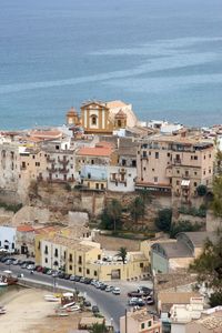 High angle view of cityscape by sea against sky