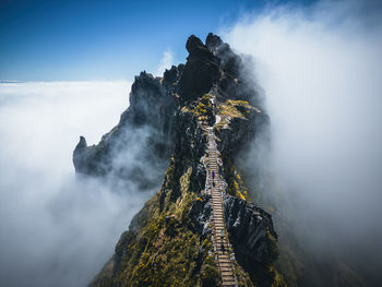 Aerial view at exposed footpath on pico do arieiro above clouds, madeira, portugal