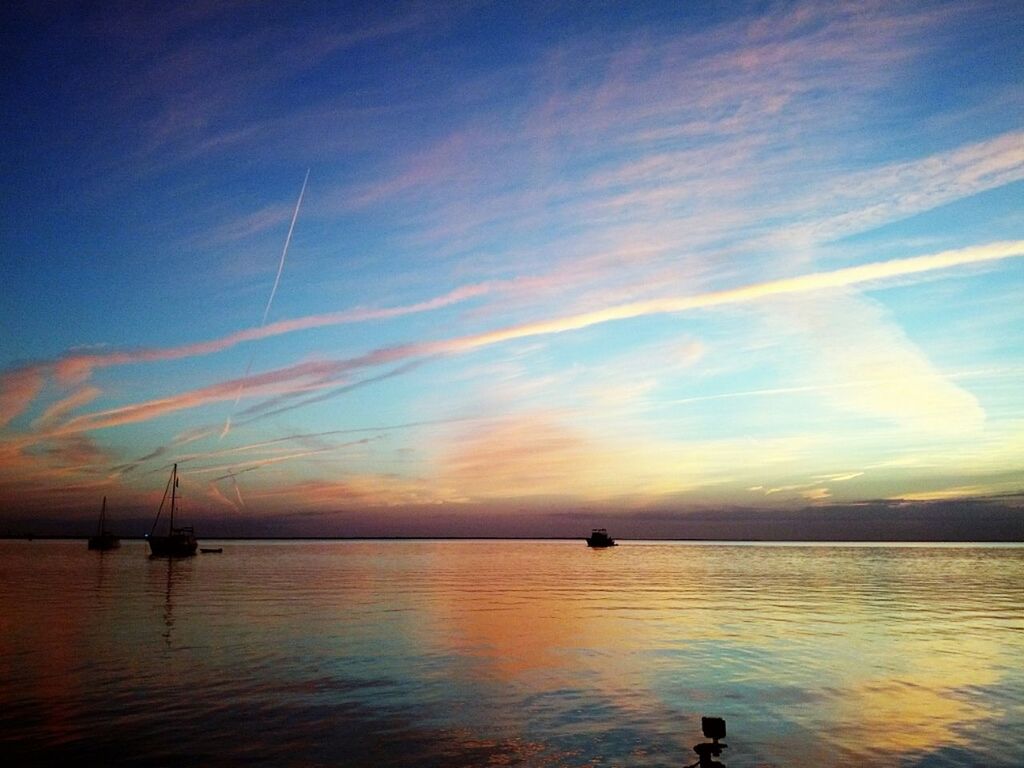 sunset, water, scenics, tranquility, tranquil scene, sky, beauty in nature, sea, silhouette, reflection, nature, waterfront, idyllic, nautical vessel, cloud - sky, horizon over water, transportation, orange color, boat, cloud