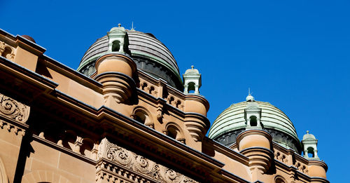 Low angle view of building against clear blue sky