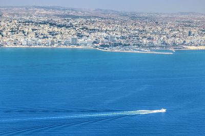 High angle view of sea and buildings in city