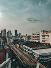 Railroad tracks amidst buildings in city