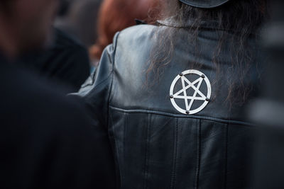 Midsection of woman wearing leather jacket