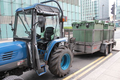 Vehicles on road against buildings in city