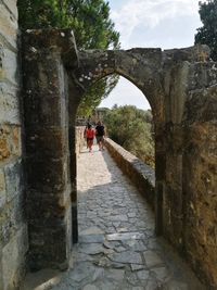 Rear view of people walking on footpath