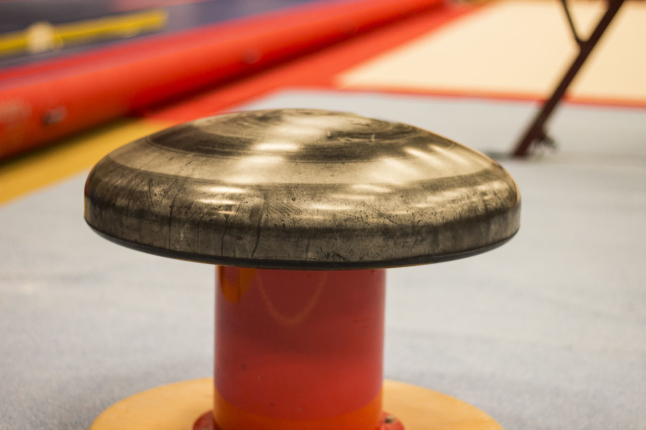 CLOSE-UP OF METAL ON TABLE AT SIDEWALK