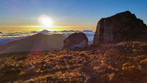 Scenic view of rocks against sky during sunset