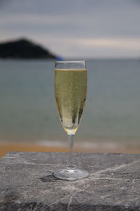 Close-up of drink on beach