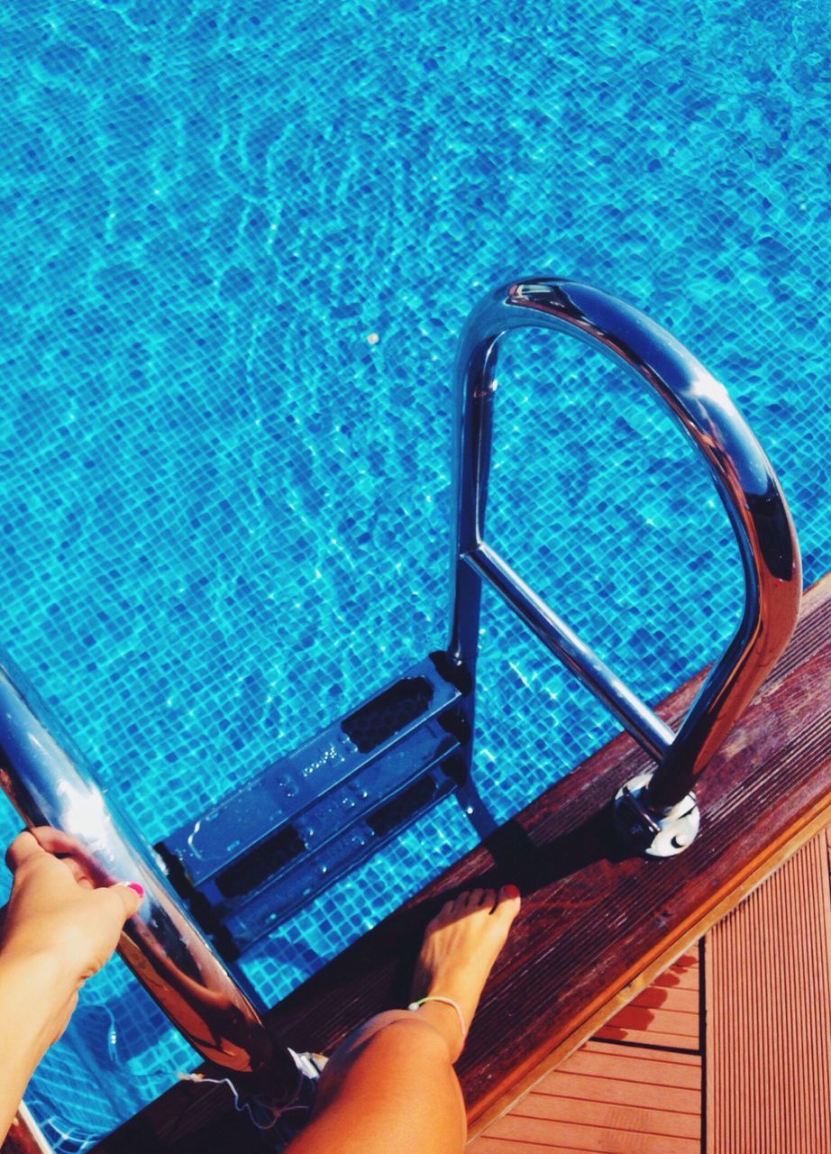 personal perspective, part of, water, swimming pool, cropped, low section, person, leisure activity, lifestyles, blue, high angle view, unrecognizable person, holding, sea, day