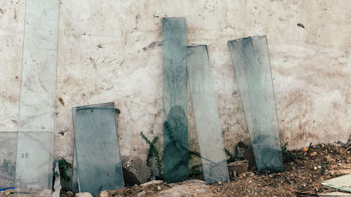 Broken glass leaning against wall