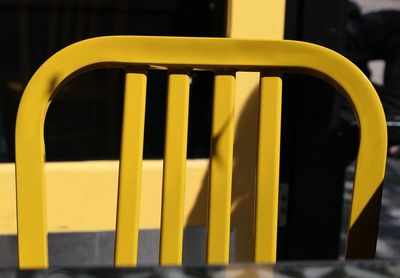 Close-up of yellow chair at outdoor cafe