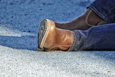 Low section man sitting on footpath