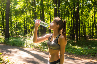 Full length of a woman drinking glass