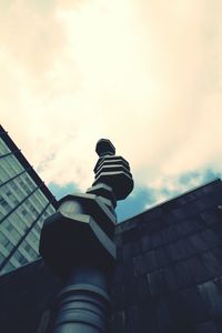 Low angle view of building against cloudy sky