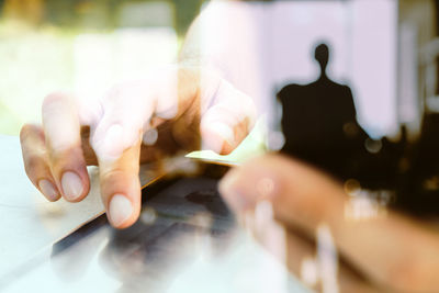 Midsection of man holding camera on table