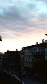 Buildings in city against sky during sunset