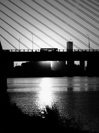 Low angle view of suspension bridge over river