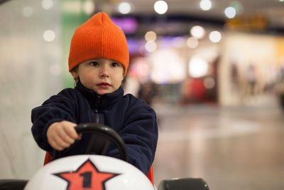 Close-up of a girl driving a toy car