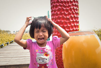 Portrait of cute girl standing in pink clothing