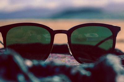 Close-up of sunglasses on water