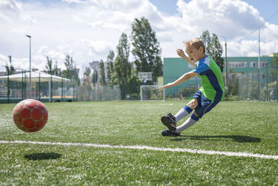 Boy playing soccer on field