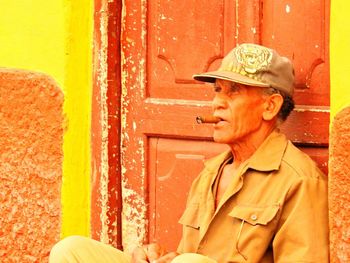 Mid adult man standing against wall