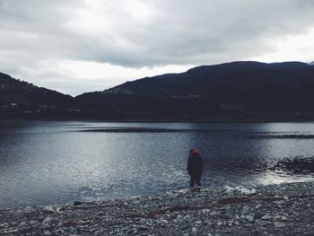 Scenic view of lake against cloudy sky