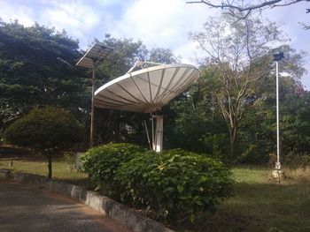 Gazebo in garden against sky