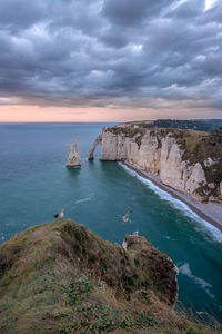 Scenic aerial view of the cliffs of Étretat at sunset. 