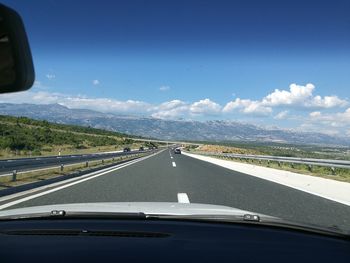 Road seen through car windshield