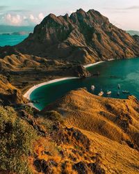 Scenic view of sea and mountains against sky