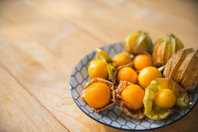 High angle view of tomatoes in plate on table