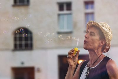 Portrait of young man holding bubbles