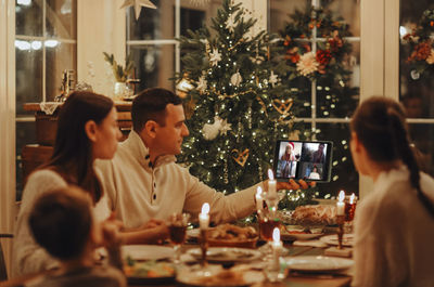 Rear view of woman with christmas tree