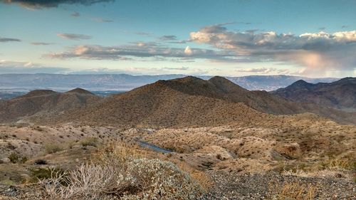 Scenic view of mountains against cloudy sky