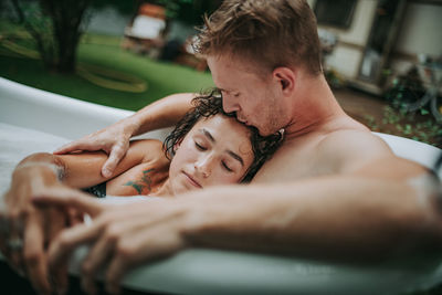 Couple in bathtub outdoors