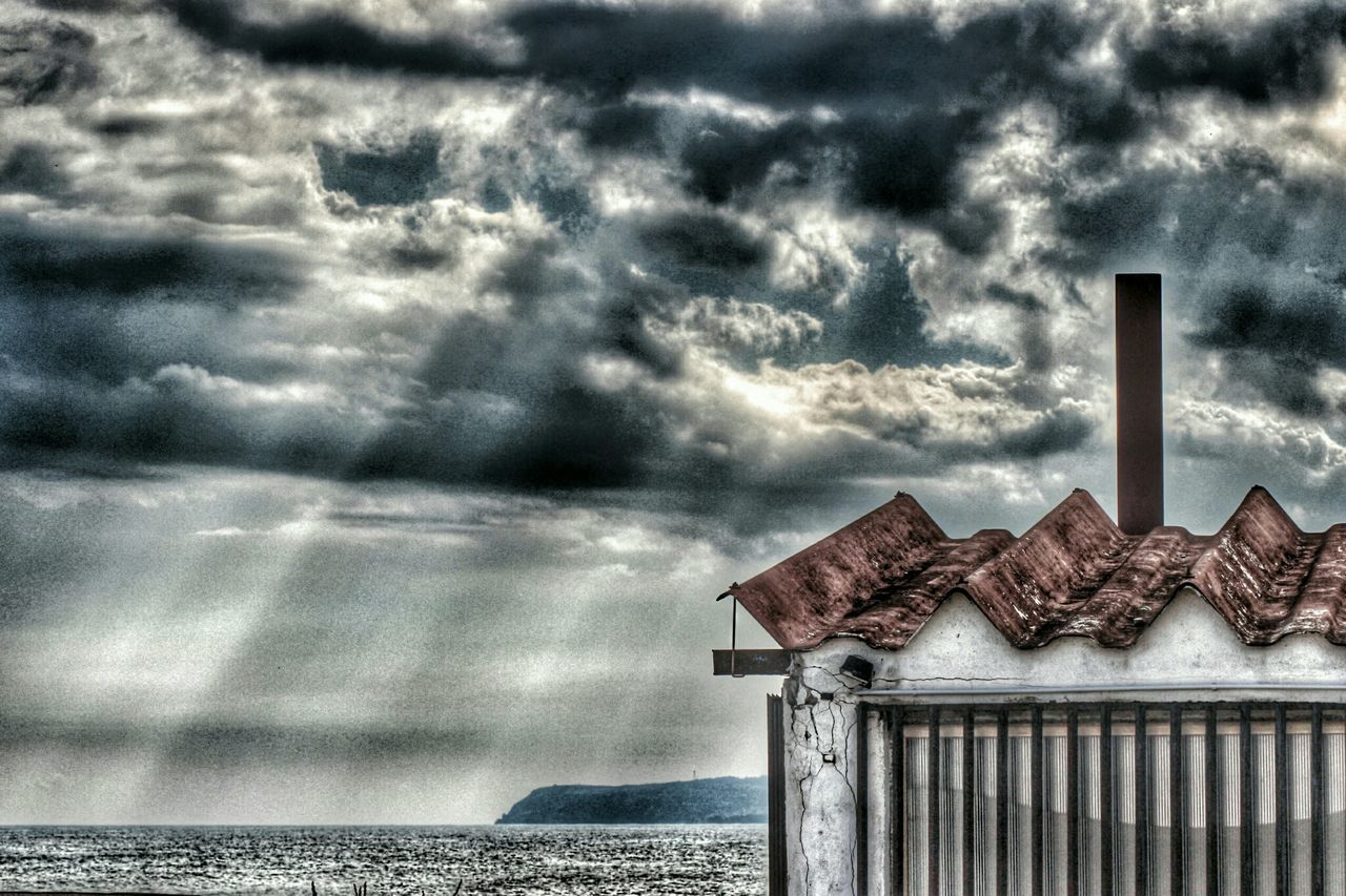 sky, cloud - sky, cloudy, weather, built structure, architecture, building exterior, cloud, sea, tranquility, scenics, nature, tranquil scene, overcast, beauty in nature, outdoors, day, no people, roof, house