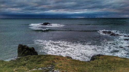 Scenic view of sea against cloudy sky