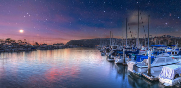 Moon and stars over boats at the harbor of dana point, california