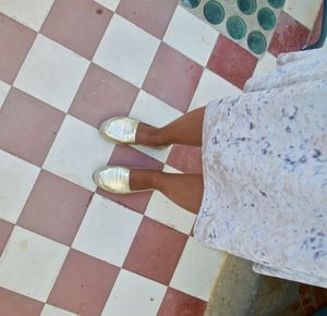 Low section of woman on tiled floor