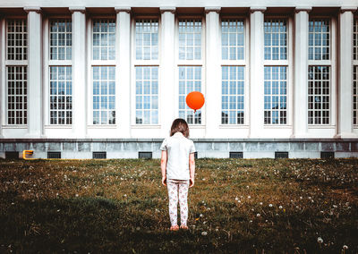 Rear view of man standing at balloon